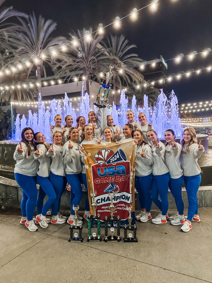 The Westwood cheer team posing with their Nationals trophy.